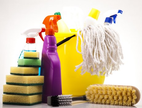 Protective gloves and cleaning supplies arranged for safe use